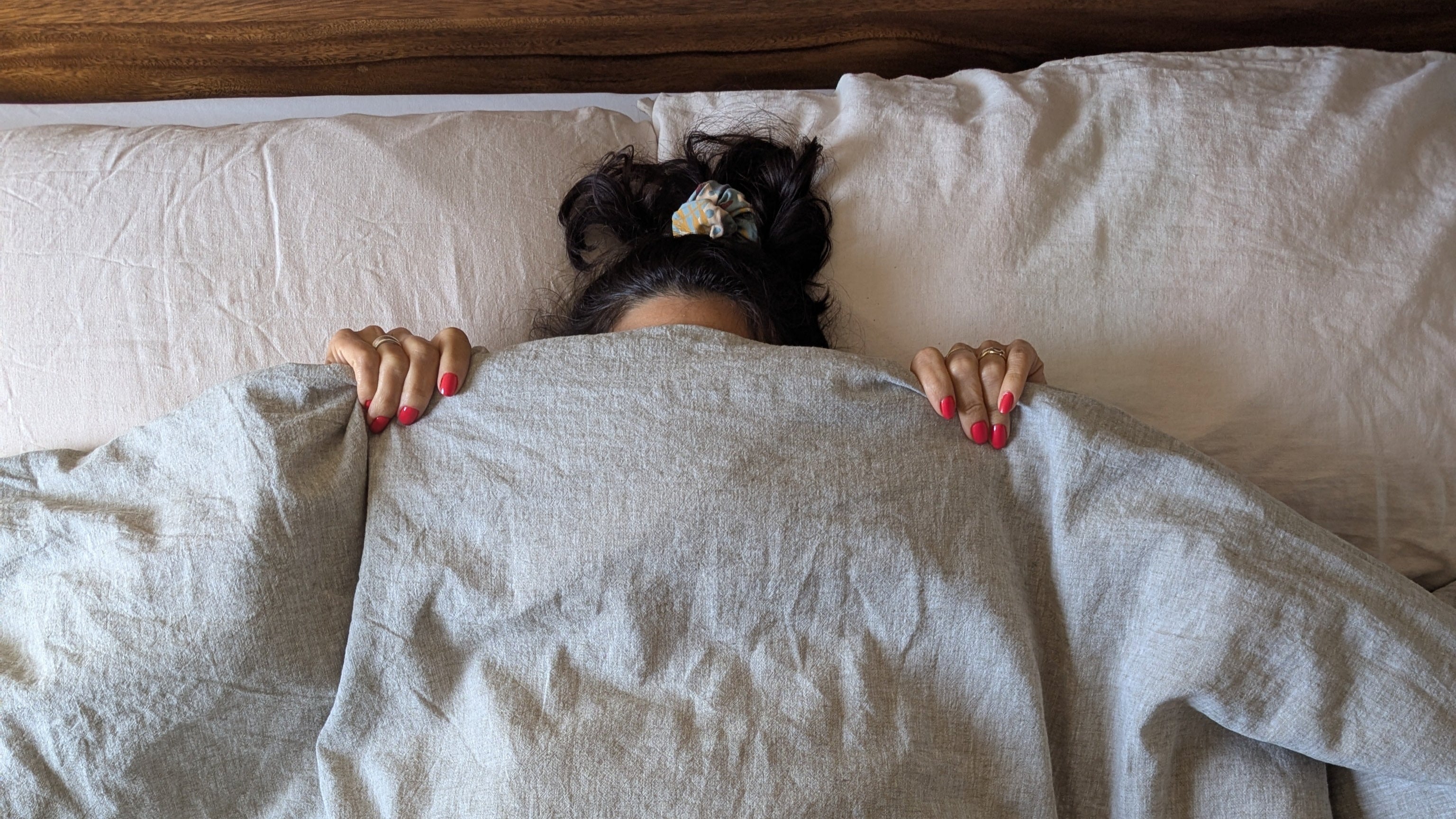 Taupe & Olive Cotton Linen Bedding with woman under comforter